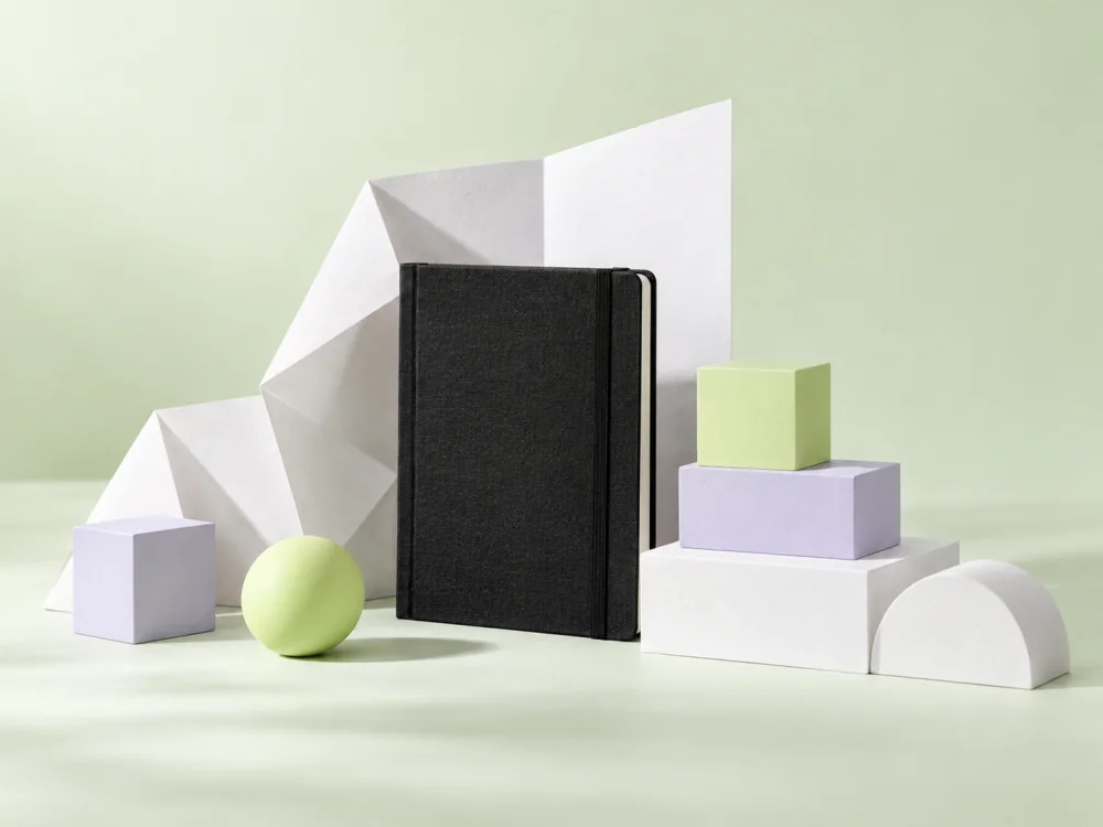 Tactile paper and geometric blocks arranged into an ordered structure.